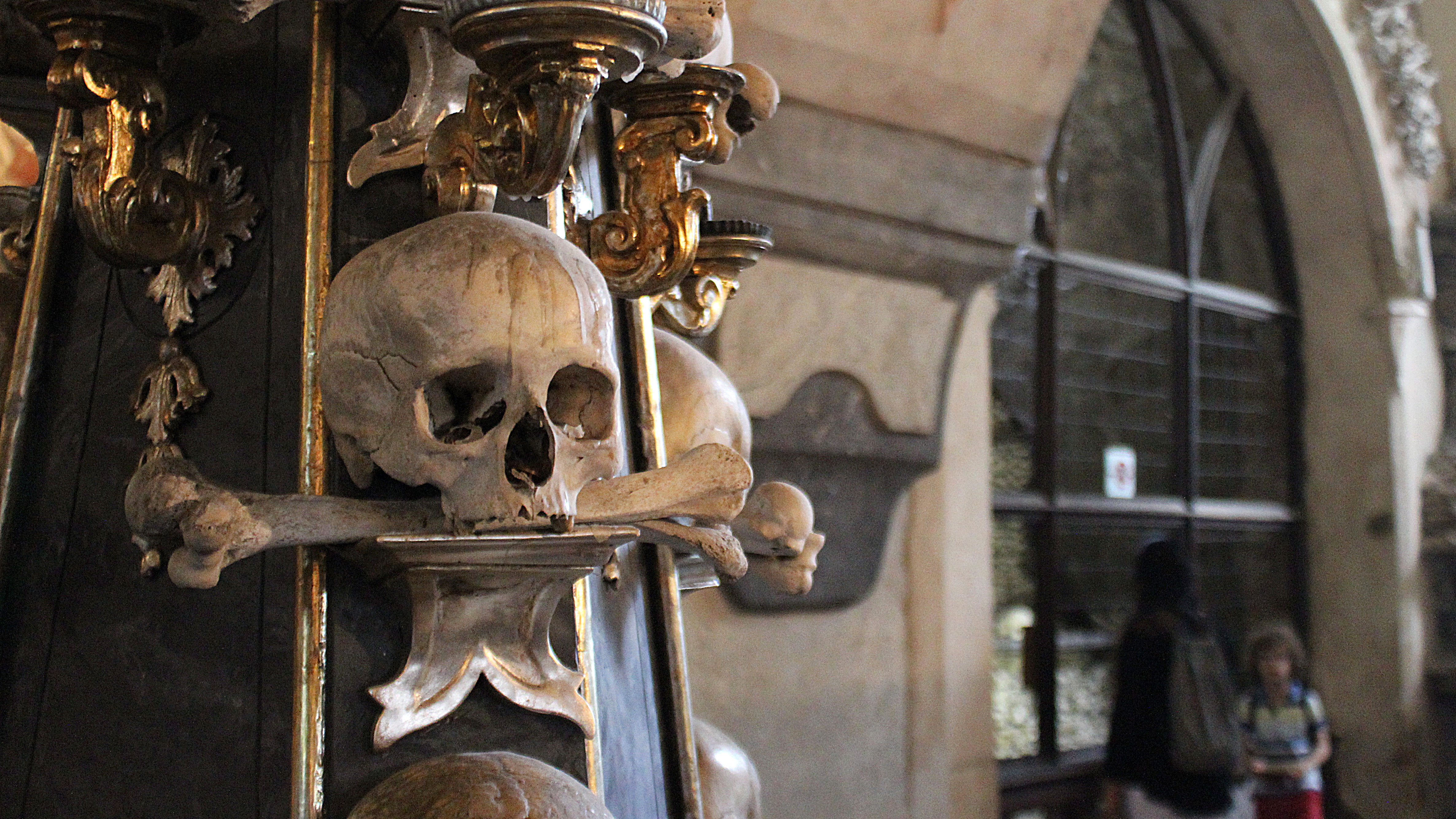 Sedlec Ossuary or Skull Church in Kutná Hora with a skull decoration in front.