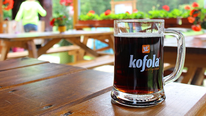 A glass of Kofola on a terace in the summer.