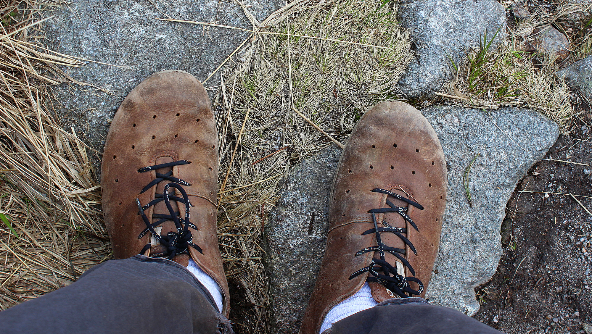 Amateur hiking tips for day hiking. Worn Ecco Biom leather shoes on rock.